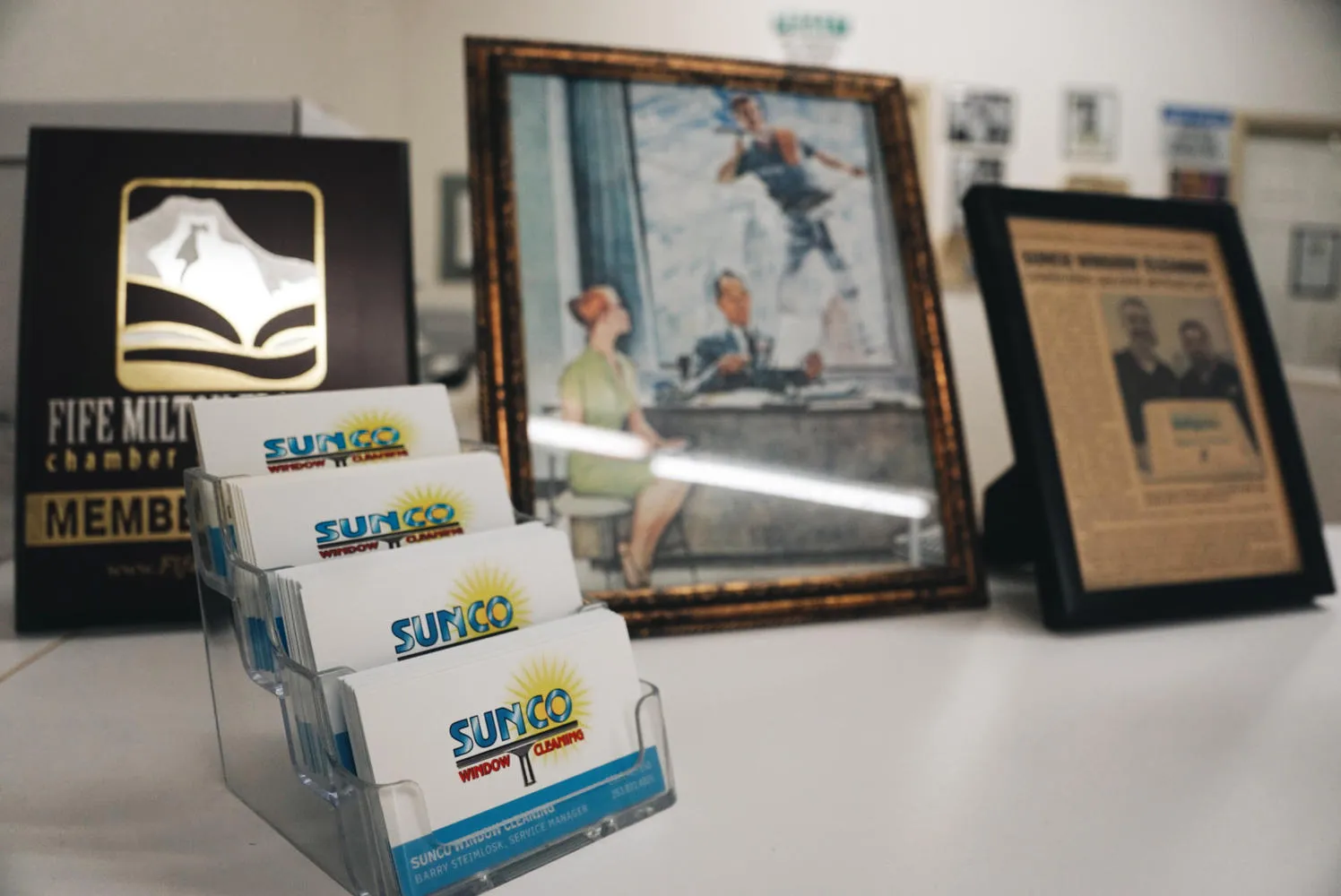 Sunco Window Cleaning local community outreach display featuring Fife Milton Edgewood Chamber plaque and business cards