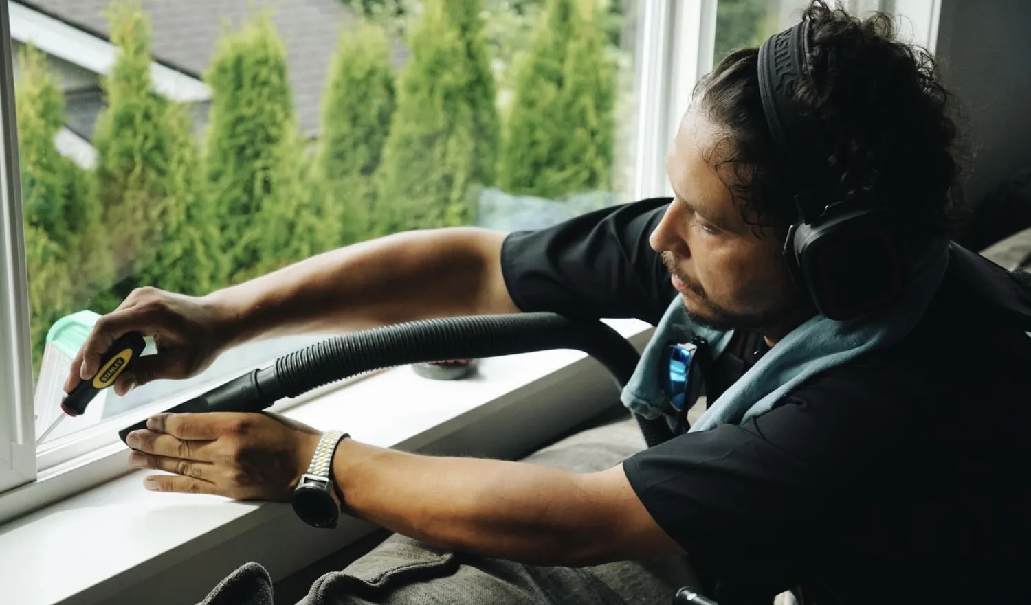 Close up of technician providing recurring deep cleaning for window tracks and sills in an Edgewood Washington residence.